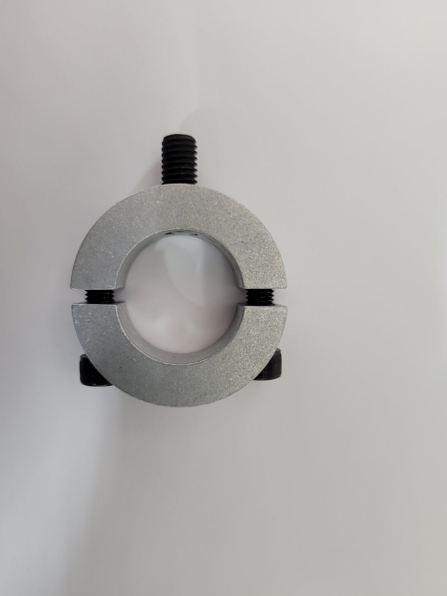 Metal clamp securing plastic fuel tank to kart post