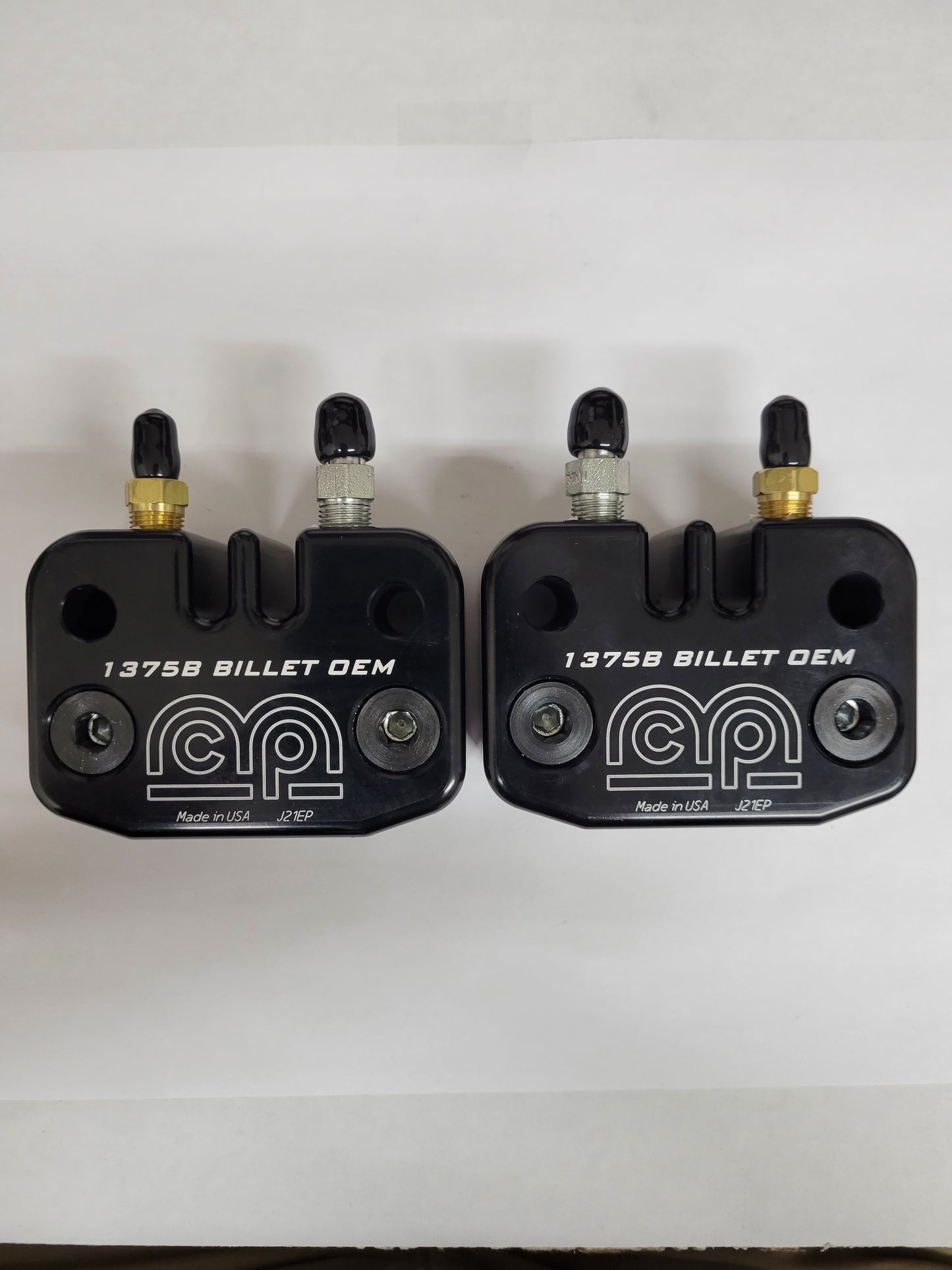 Two-piece billet caliper with AN-3 fittings and black pads installed