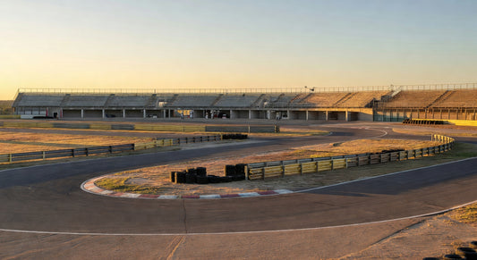 Paved sprint kart track bathed in golden hour light, ready for racing action.