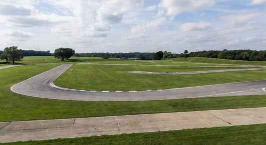 Wide landscape of a Midwest 4-cycle kart racing track under clear skies