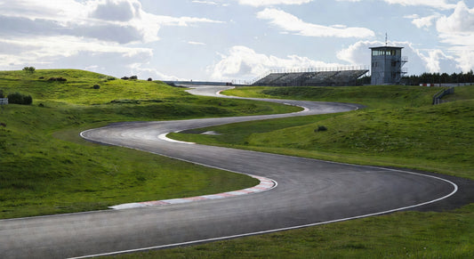 Paved sprint kart track landscape with hills and grandstands