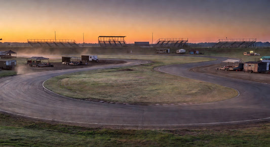 Dirt oval kart track at sunset, evoking race-ready vibes.