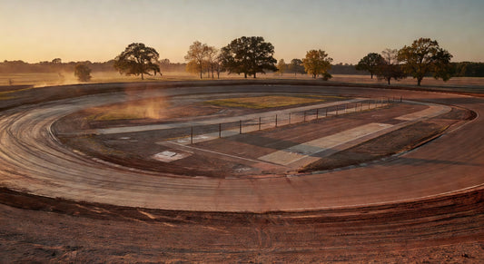 Scenic dirt oval kart track bathed in golden hour light.
