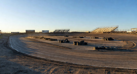 Midwest dirt kart track landscape with empty pits at golden hour