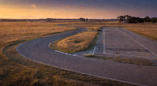 Paved sprint kart track at dusk, ideal setting for 4-cycle maintenance sessions.
