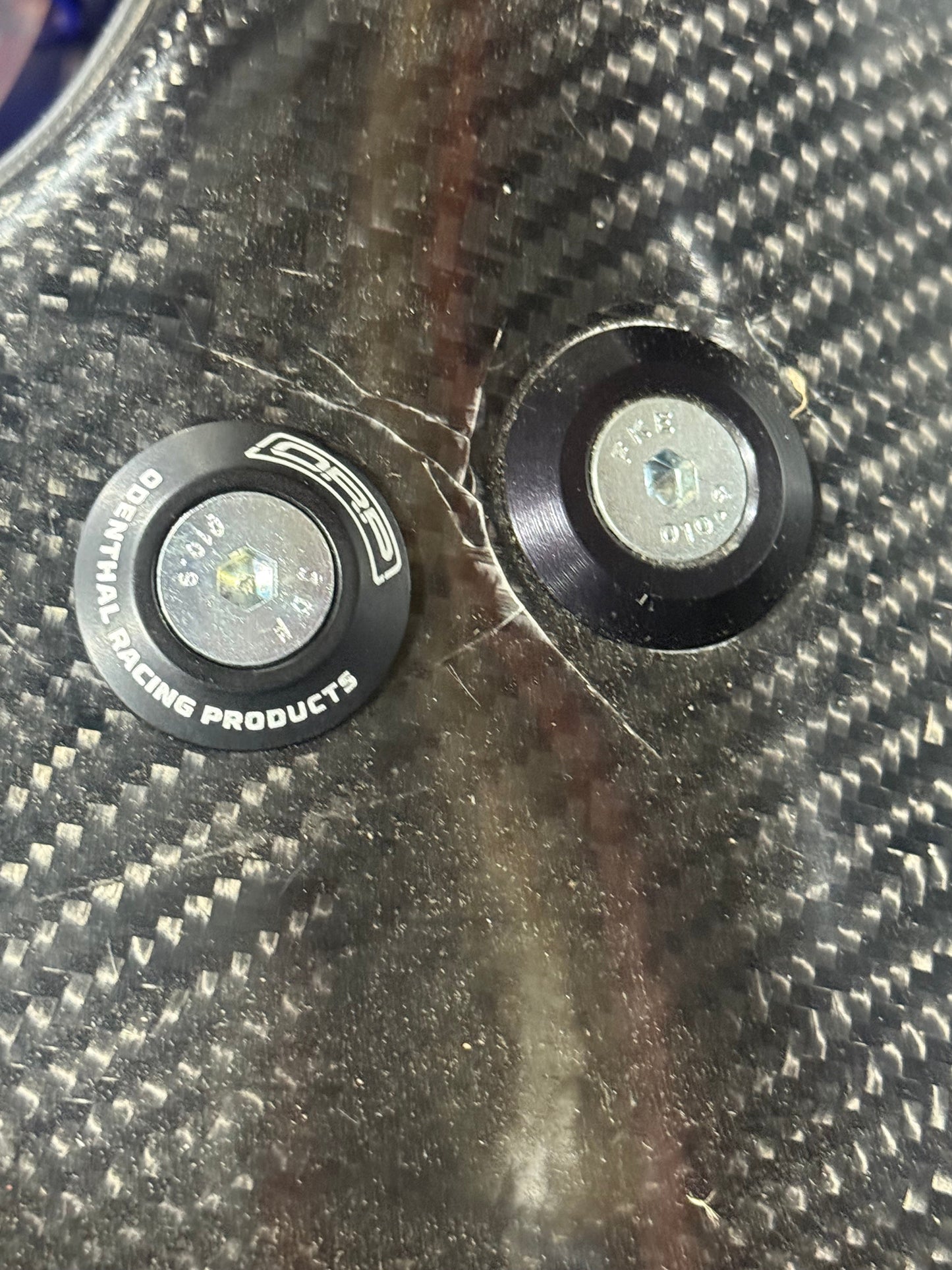 8mm low profile seat washer installed on carbon fiber kart seat next to standard bolt showing low stack height