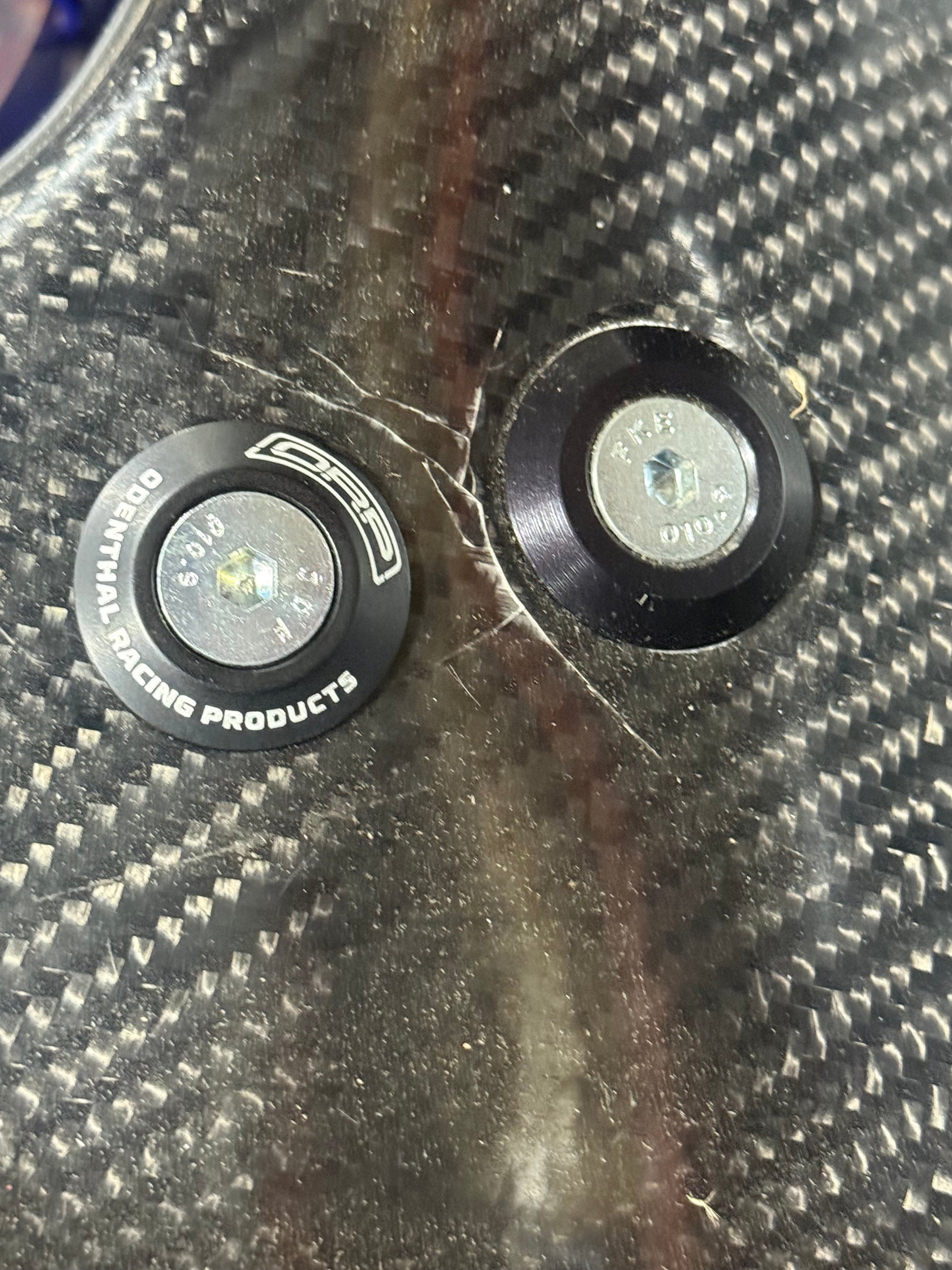 8mm low profile seat washer installed on carbon fiber kart seat next to standard bolt showing low stack height