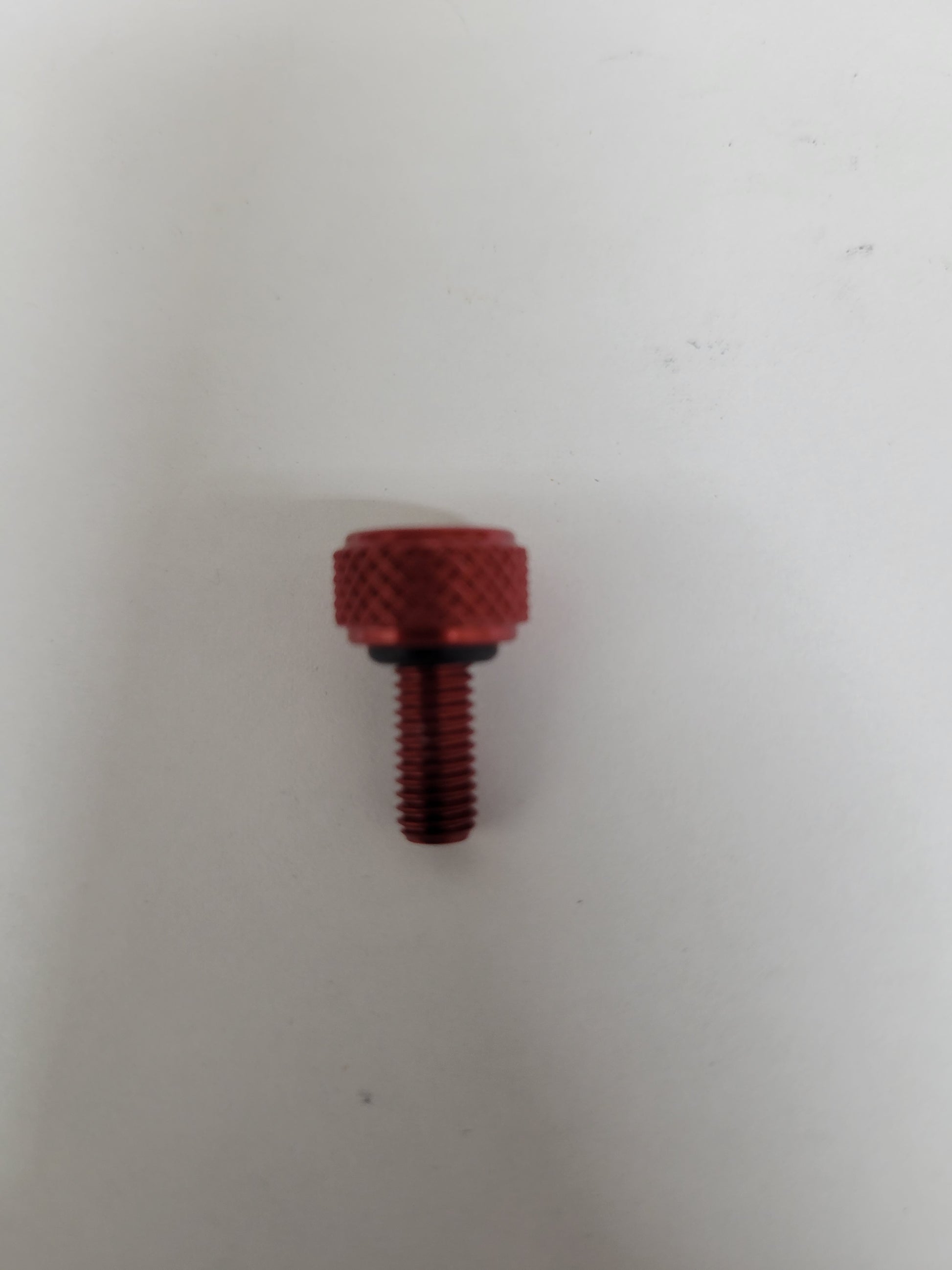 Red anodized aluminum bead lock screw with knurled head, O-ring, and 5mm thread for kart wheels