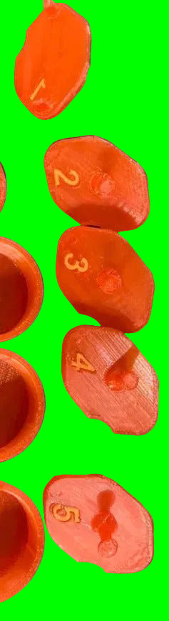 5 exhaust caps for lo206 or animal that are numbered 1 thru 5 on a light blue background. To the left you can see some of  the inside of the caps that also go on the end of a lo206 or animal carburetor. The caps are a red slight pink color, with orange numbering on a neon green background.