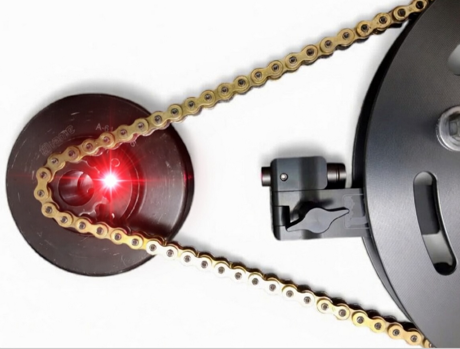 Laser alignment showing to be working with a gear guard setup, it fits between the gear guard to align properly. Showing a bright red laser dot pointing at the clutch on a white background.