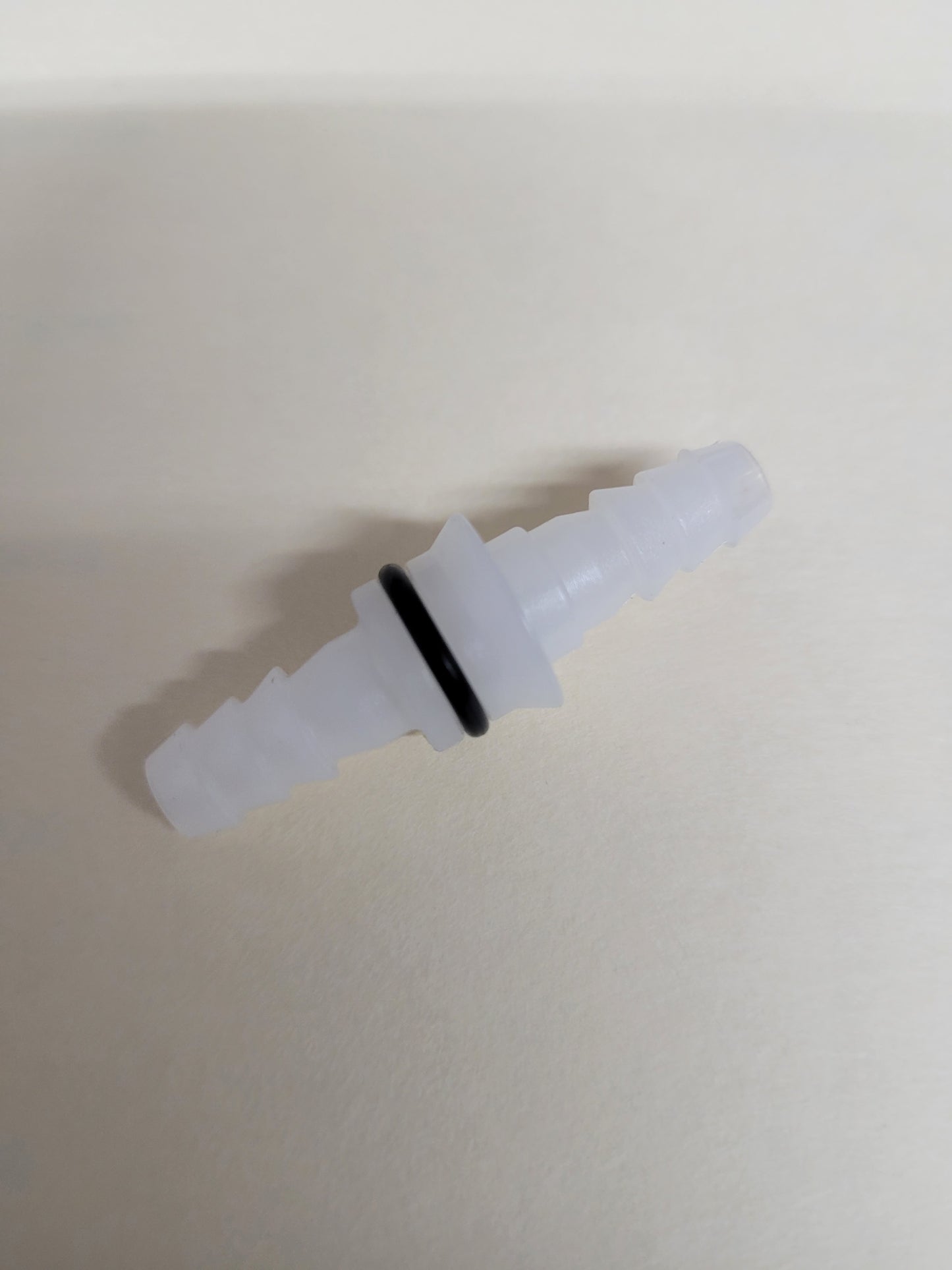 White plastic PUFT replacement outlet fitting with O-ring and barbed ends for kart fuel systems