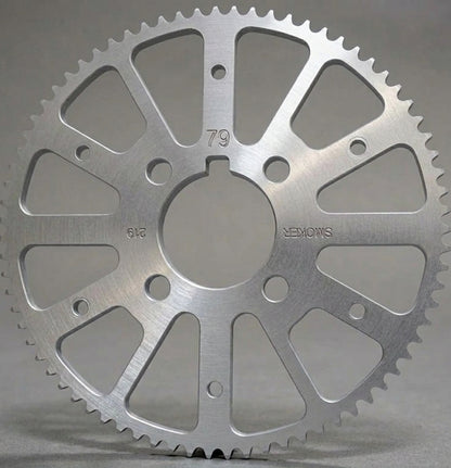 A silver metallic sprocket gear, photographed on a neutral gray background. The gear has engraved markings including '79', '612', and 'SMOKER' all marking are upside down except '79'.