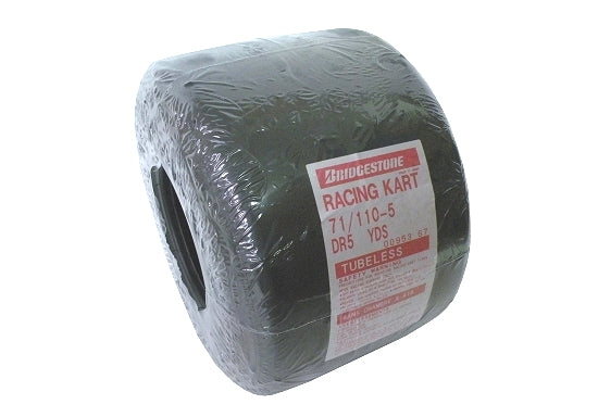 Close-up of Bridgestone YDS710 11x710x5 slick kart tire on white background
