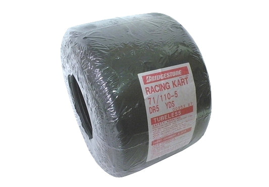 Close-up of Bridgestone YDS710 11x710x5 slick kart tire on white background