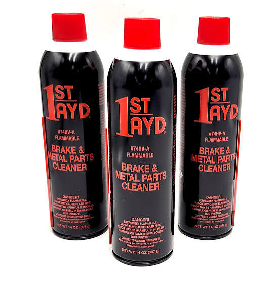 Three black 1ST AYD brake and metal parts cleaner aerosol cans with red caps and safety labels on a white background