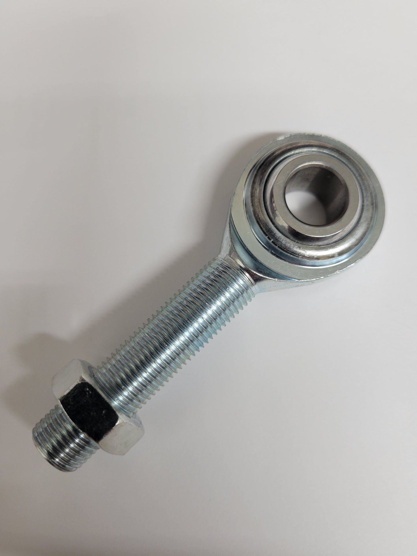 Close-up of long 1/2" heim joint with nut for kart steering