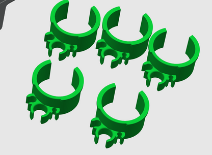 Five green PETG 3D printed fuel line clips shown from different angles highlighting C-shape and cable slots on a gray background