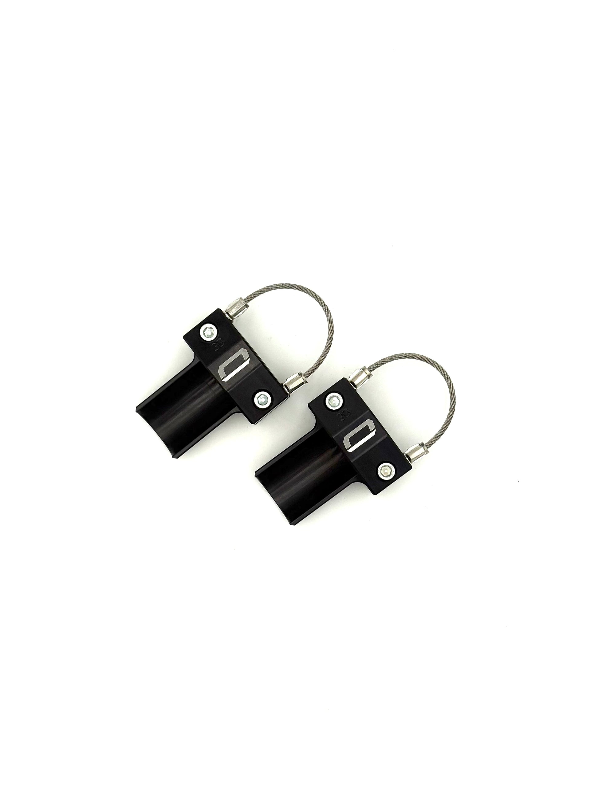 Overhead view of pair of black EZBR rear bumper safety clamps showing full braided steel cable on a white background