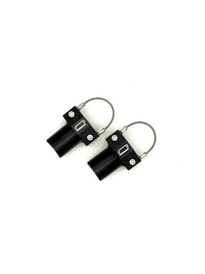 Overhead view of pair of black EZBR rear bumper safety clamps showing full braided steel cable on a white background