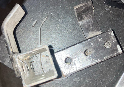 End view of bare metal kart stand pickup bracket showing square tube receiver and hook detail on a workbench