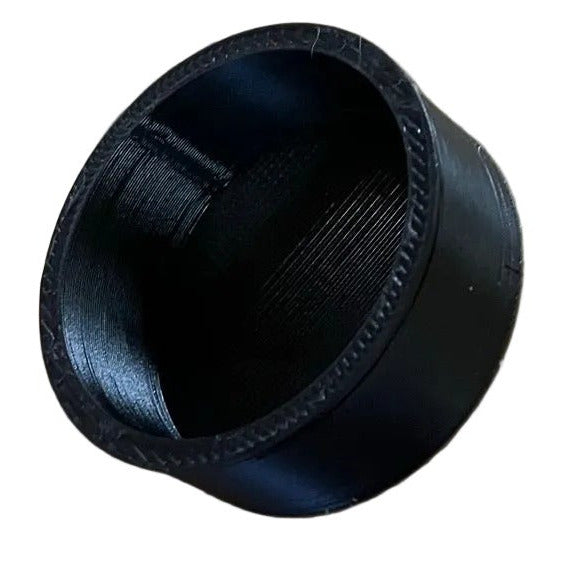 Carburetor cover cap on a white background, showing the side that slides onto carb