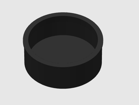 A carburetor cap, from the view of the end that goes over the end of the carburetor, sitting on top of a white background.