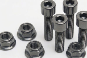 Titanium M6 sprocket hub bolts and flanged nuts on a white background