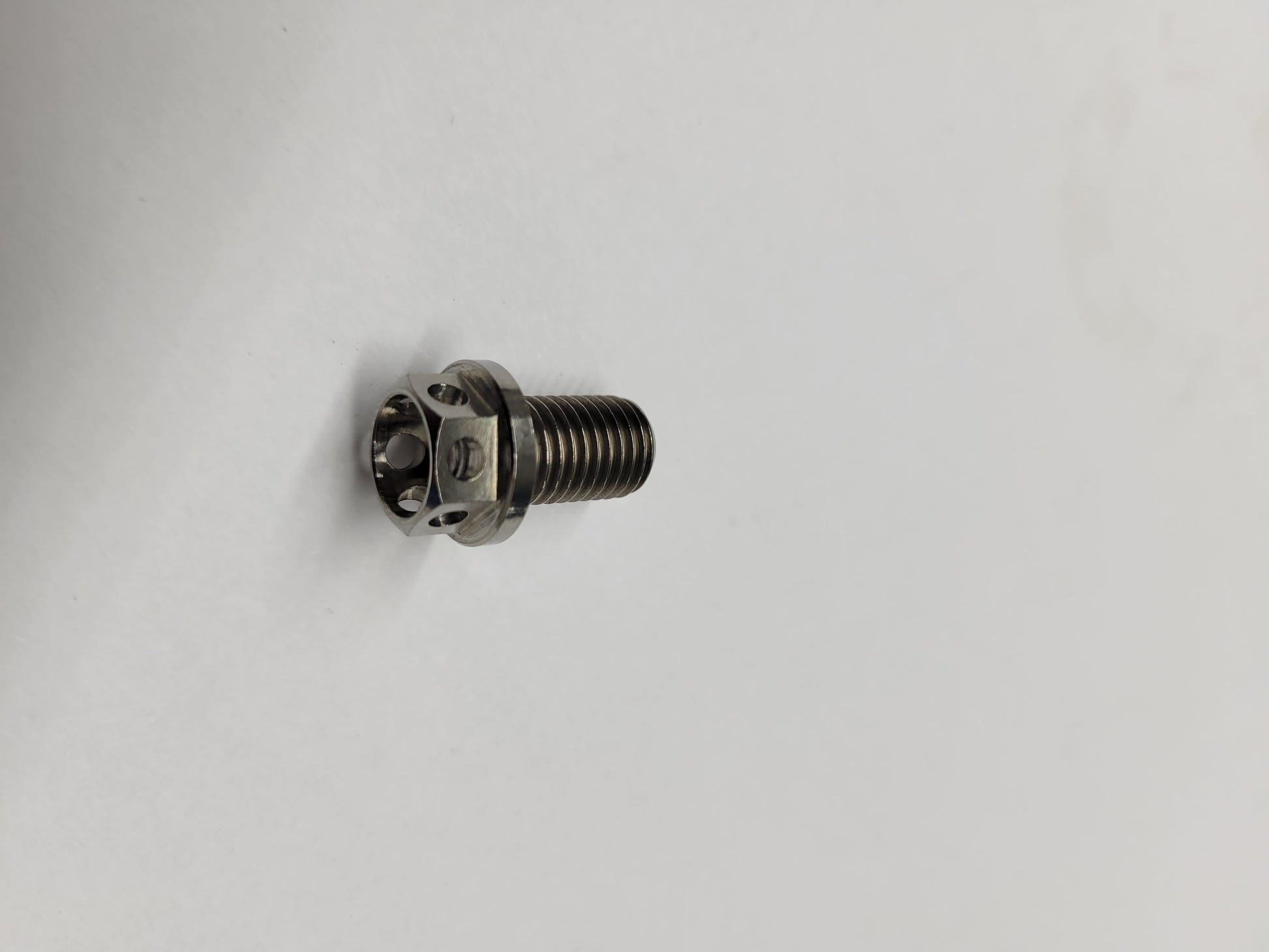 Titanium drilled brake hub bolt for Phantom kart hub close-up