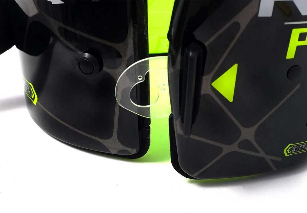 Close-up of the black and neon green karting rib vest / chest protector  plastic latch, very hard plastic, doesn't break easy, and n a white background.