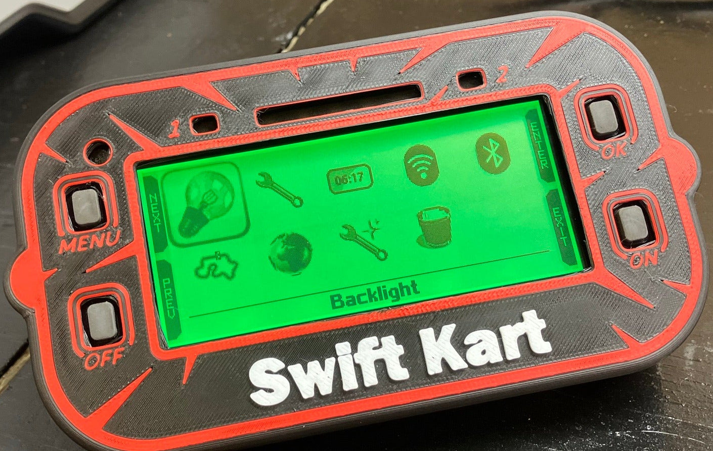 Black Mychron 6 Case, Red Design with  White Text. Mychron 6 installed in case, with a green background illuminated. 