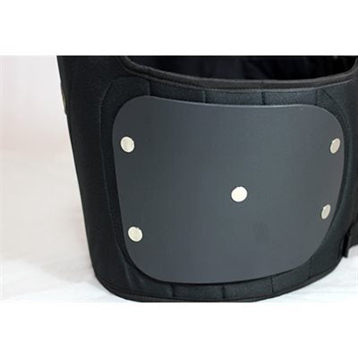 Close view from lower angle showing thickness and rivet attachments of the polymer panel on black Ribtect 4 child karting vest on a white background