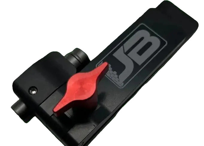 Close-up angled view of black Smoker Chain Aligner highlighting red adjustment knob and laser emitter on black background