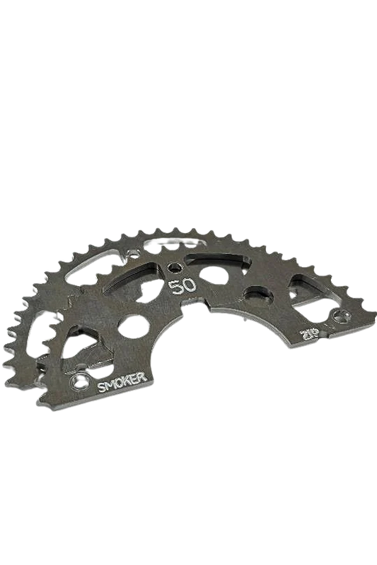 Close-up of a black ultra-light Smoker Performance #219 sprocket showing laser-etched 50T count, SMOKER branding, lightening holes, and mounting points against a black background.