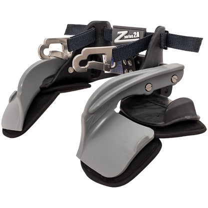 Z-Tech Series 2A black and gray head and neck restraint side profile showing curved gray arm, black padding, metal buckle and shoulder strap on a white background