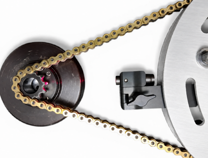 Laser aligner system showing to be working in between a sprocket guard on a white background with a 219 did chain and lo206 kart clutch with a white background.