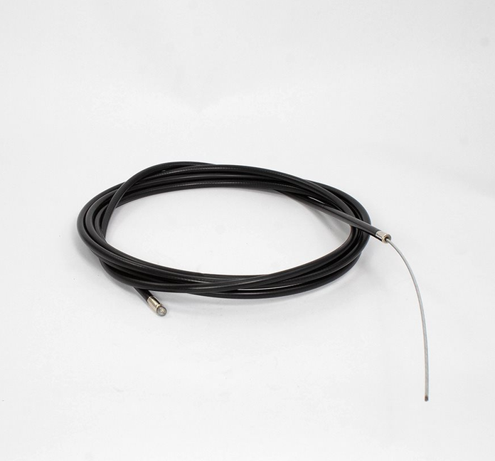 A coiled black karting throttle cable housing with a thin silver metal accelerator cable probe extending from one end, photographed on a clean white studio background.