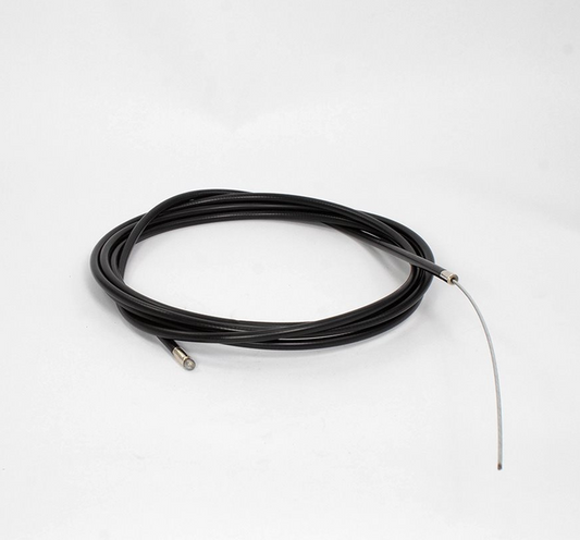 A coiled black karting throttle cable housing with a thin silver metal accelerator cable probe extending from one end, photographed on a clean white studio background.