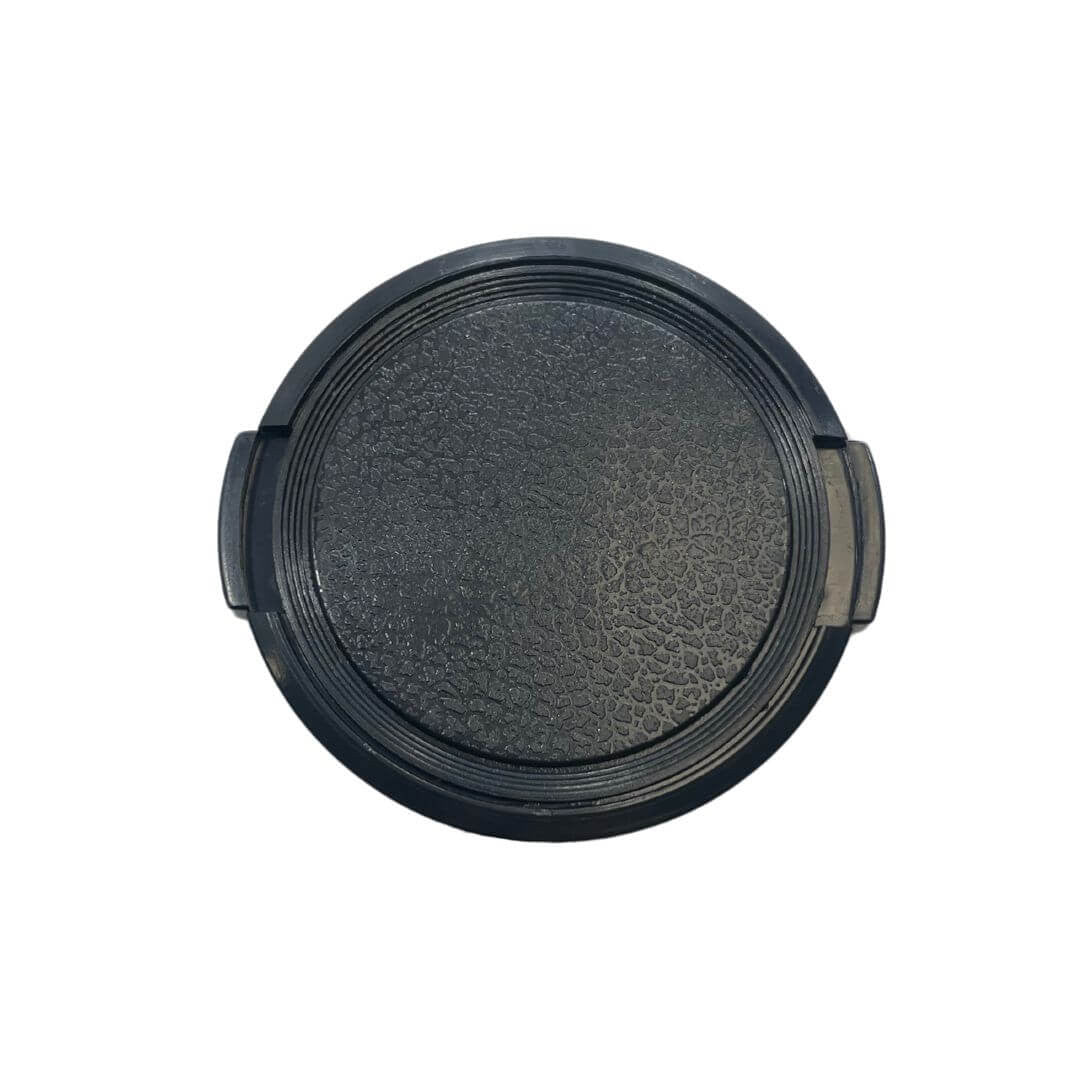 Top-down view of black polycarbonate Tuff-Kase GoPro lens cover showing textured center surface, concentric sealing ribs, and two side mounting tabs on a white background