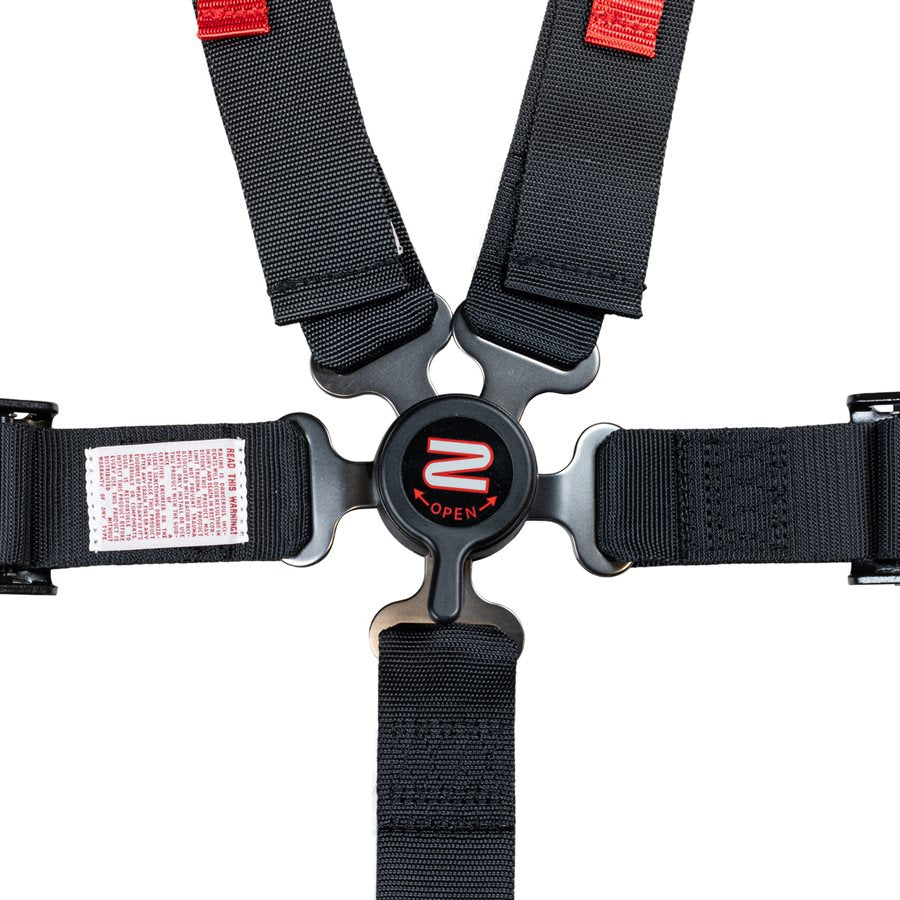 Close-up of Zamp camlock buckle on youth 5 point kart harness with all five straps clicked in showing red OPEN marking and release lever on a white background