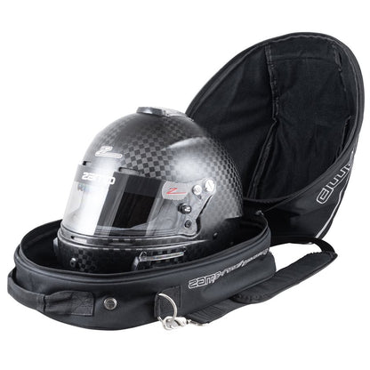 Open black Zamp helmet bag with fan containing a carbon fiber kart racing helmet to demonstrate scale fit and soft interior lining on a white background