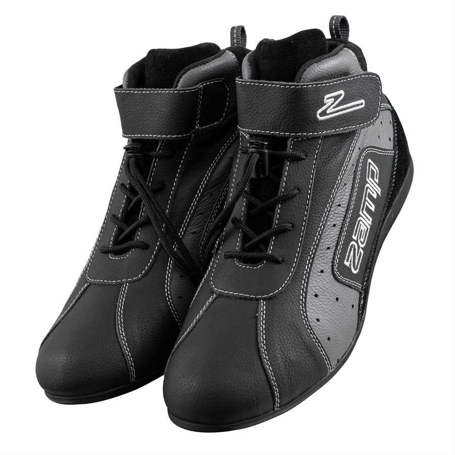 Pair of black Zamp ZK-20 kart shoes in front three-quarter view with laces, white stitching, velcro straps featuring Z logo, and side Zamp branding on a white background