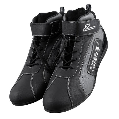 Pair of black Zamp ZK-20 kart shoes in front three-quarter view with laces, white stitching, velcro straps featuring Z logo, and side Zamp branding on a white background